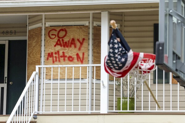 The home of the Weibel family is boarded up in preparation for Hurricane Milton on Oct. 7, 2024, in Port Richey, Fla. (AP Photo/Mike Carlson)